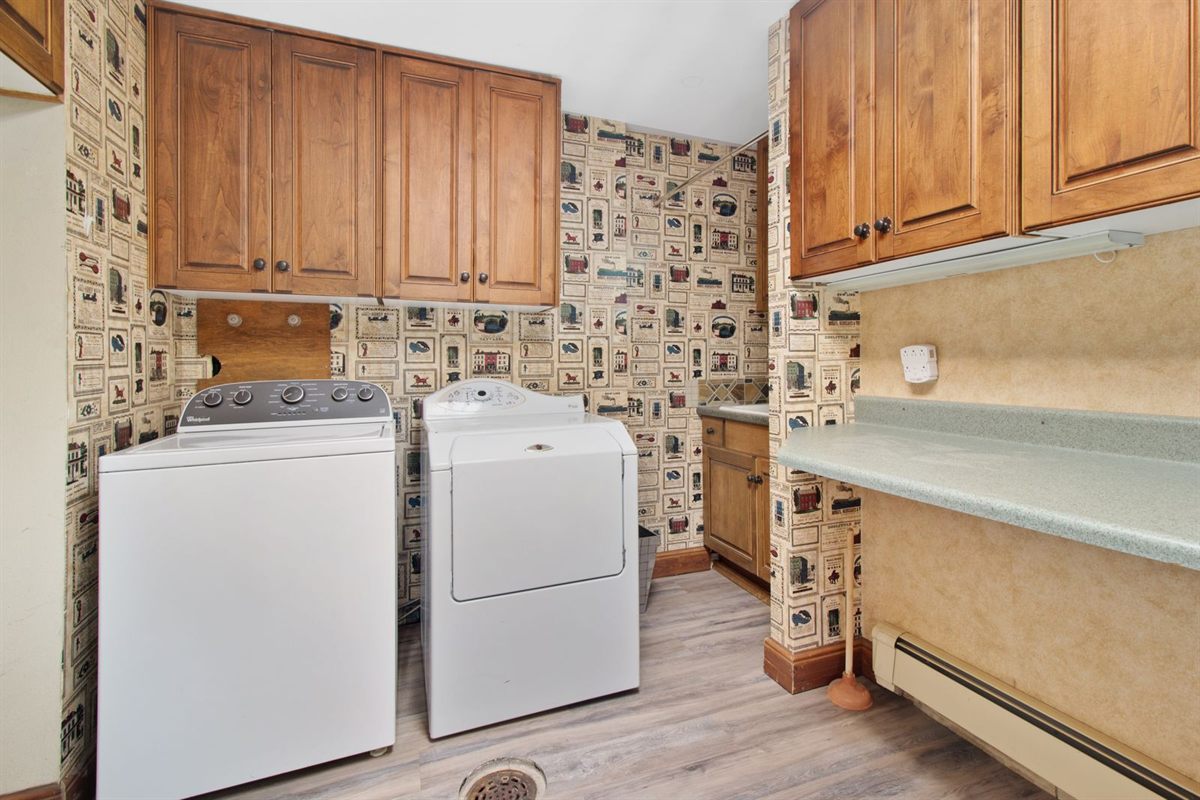 Top-load washer and dryer side by side in a home laundry room