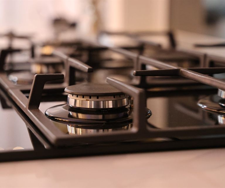 Close-up of a stainless steel cooktop with cast-iron grates